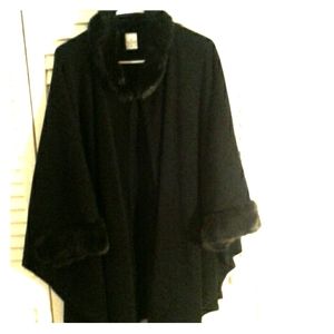 Black cape with fur lined collar and wrists.
